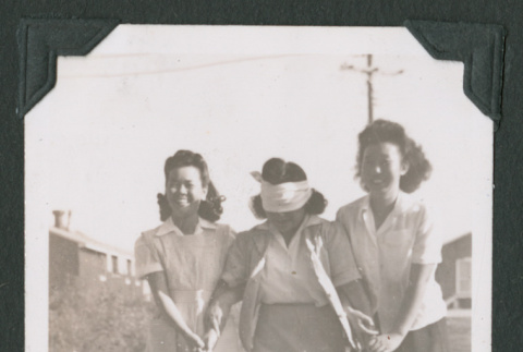 Two women lead a blindfolded woman (ddr-densho-471-46)