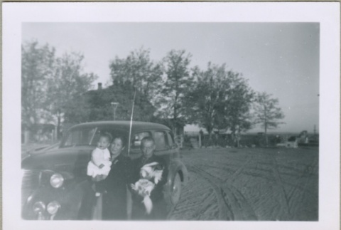 A family standing in front of a car (ddr-densho-300-39)