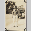Man in sunglasses standing near car (ddr-densho-423-512)