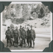 Eight men in uniform standing alongside road (ddr-ajah-2-317)