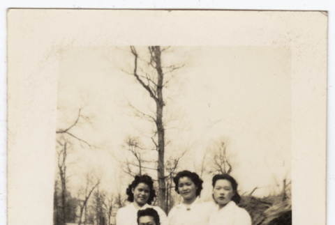 Four people in wooded area (ddr-densho-356-128)