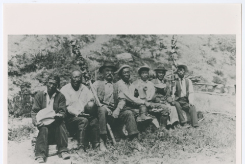 Seven figures seated outside (ddr-densho-1007-24)