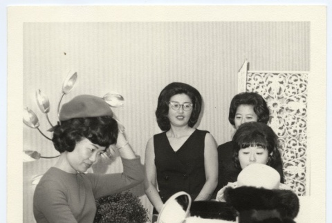 Woman trying on hats (ddr-jamsj-1-452)