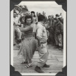 Man and woman in grass skirt dancing (ddr-densho-466-148)