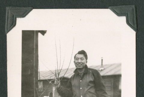 Man holding tree (ddr-densho-471-52)