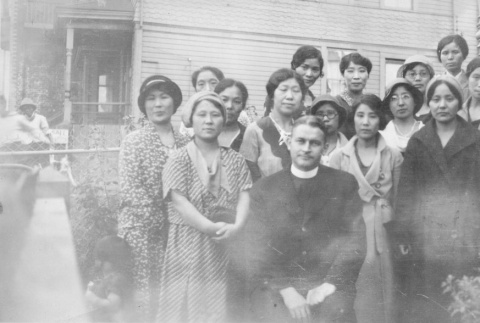 (Photograph) - Image of priest with women in yard (ddr-densho-330-257-master-3b7905e1b5)