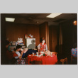 Tomoye Takahashi standing behind table (ddr-densho-426-1296)
