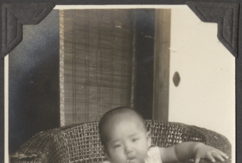 A baby sitting in a chair (ddr-densho-432-169)