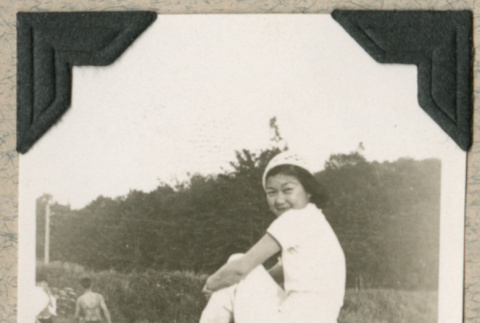 Shigeko Sesse sitting on log (ddr-densho-383-286)