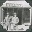 Two men standing outside post office (ddr-ajah-2-350)