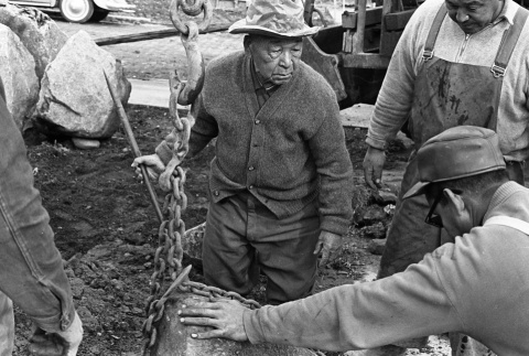 Fujitaro Kubota, Tom Kubota and assistant setting stone, Seattle University (ddr-densho-354-2083)