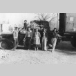 Family in front of truck with carrots (ddr-densho-187-9)