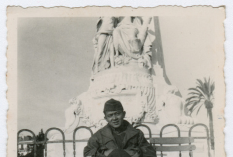 Soldier sitting in front of statue (ddr-densho-368-202)