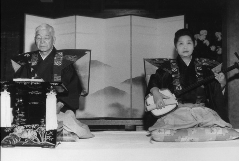 Fujitaro and Ko Kubota participating in a ceremony, Fujitaro singing (ddr-densho-354-78)
