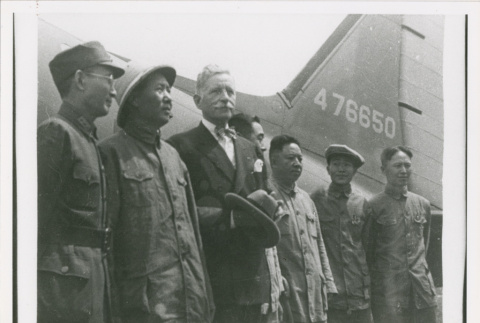 Servicepeople standing front of plane (ddr-densho-1007-178)