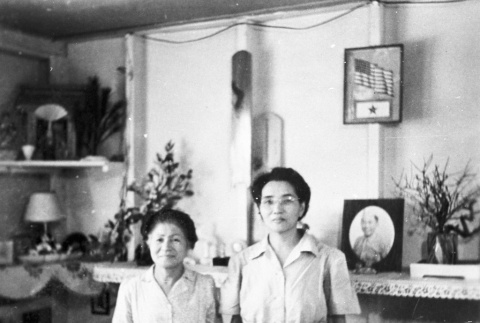 Two Japanese Americans inside barracks (ddr-densho-15-60)