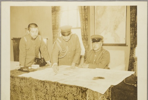 Military commanders looking at a map (ddr-njpa-13-1182)
