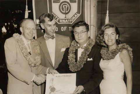 A Honolulu Optimist Club member receiving an award, posing with others (ddr-njpa-2-417)