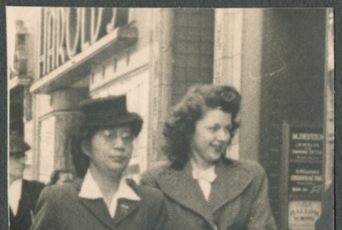 Two women walking on sidewalk (ddr-densho-523-180)