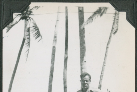 Man standing by palm trees (ddr-ajah-2-655)
