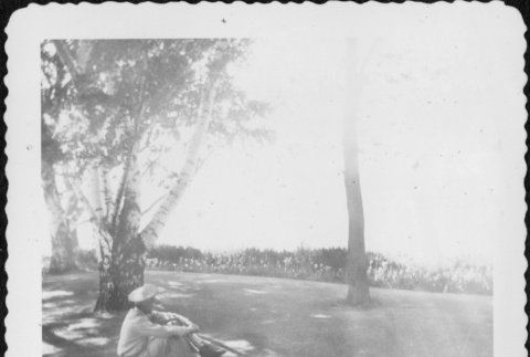 Man in uniform sitting looking at view (ddr-densho-434-414)