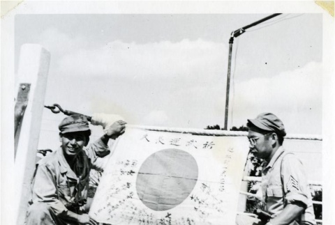 Nisei soldiers with captured Japanese flag (ddr-densho-179-63)