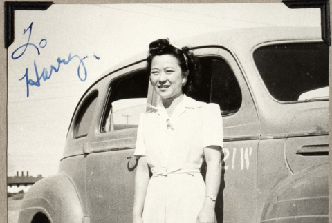 Woman standing next to car (ddr-densho-587-48)