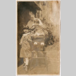 Man with children outside building (ddr-densho-426-1439)