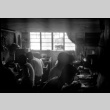 Group of men working at benches in small workshop (ddr-densho-426-2411)