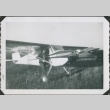 Man standing next to a propeller plane (ddr-densho-321-308)