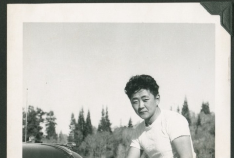 Sam Kawashima leaning against a car (ddr-densho-328-475)