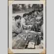 Large group of men eating at long tables (ddr-densho-466-870)