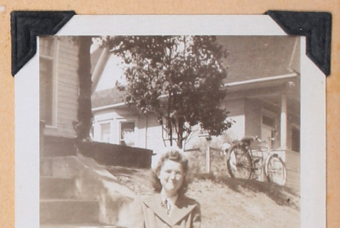 Photo of a woman sitting on front steps (ddr-densho-483-446)