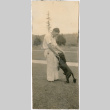 Man petting dog (ddr-densho-523-40)