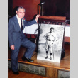Saitoro Towata standing with portrait of himself in 1927 in Alameda  baseball uniform (ddr-ajah-6-977)