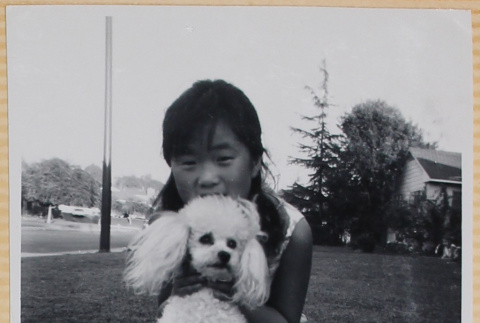 Girl holding dog (ddr-densho-522-110)