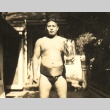 Umi Okino, a sumo wrestler posing with a trophy (ddr-njpa-4-1958)