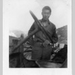 [Man in military uniform with military vehicle] (ddr-csujad-1-30)