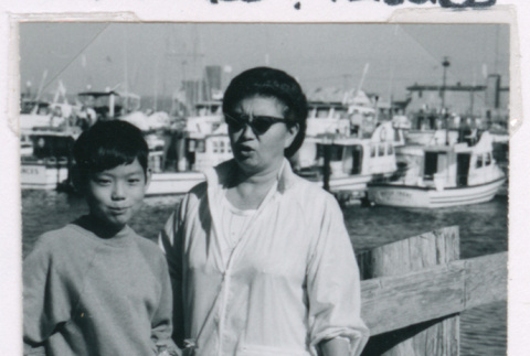 Mitzi Isoshima and Mark Isoshima in front of boats (ddr-densho-477-506)