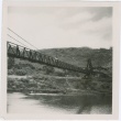 Two men standing on the swinging bridge at Menehune Ditch (ddr-densho-338-202)
