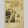 Men sitting on a car (ddr-densho-258-10)