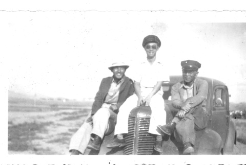 Japanese American men sitting on a car (ddr-densho-157-25)