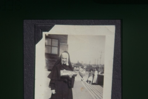 (Slide) - Image of nun with papers (ddr-densho-330-156-master-c26b89d3e4)