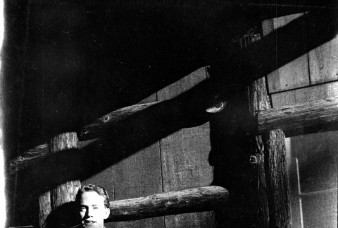 Tomoye (Nozawa) Takahashi and unknown man standing doorway of log house (ddr-densho-426-2020)