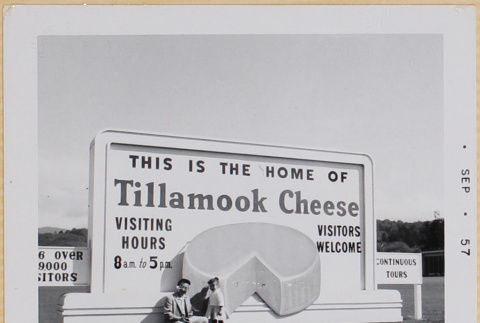 Hardy and Susan Shiomi standing by Tillamook Cheese Factory sign (ddr-densho-522-557)
