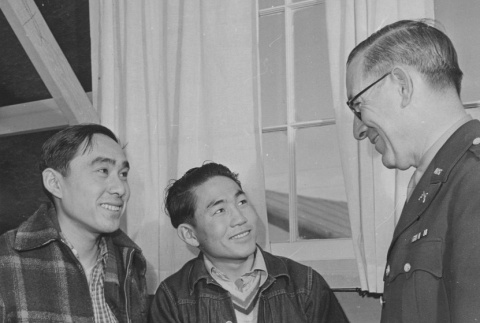 Captain William S. Fairchild discussing the army with two young Nisei volunteers (ddr-csujad-14-50)