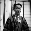 Man in robe, with name tag (ddr-densho-426-2475)