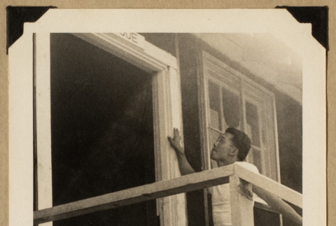 Man standing outside a doorway (ddr-densho-542-543)