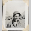 Man in helmet with tents in background (ddr-densho-466-704)