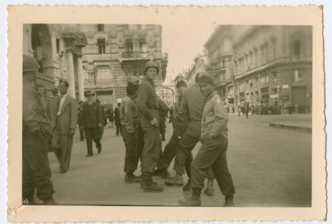 Soldiers standing on city street (ddr-densho-368-118)